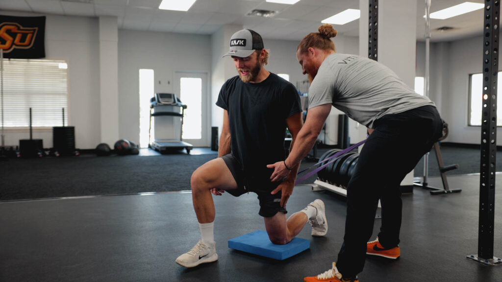 Client doing a guided exercise session during physical therapy for knee pain