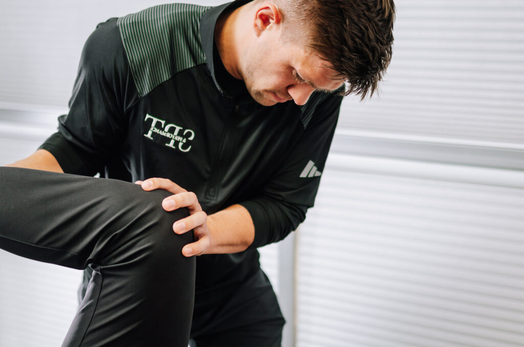 Dr. Tyler Sinda leading a physical therapy exercise session for knee pain