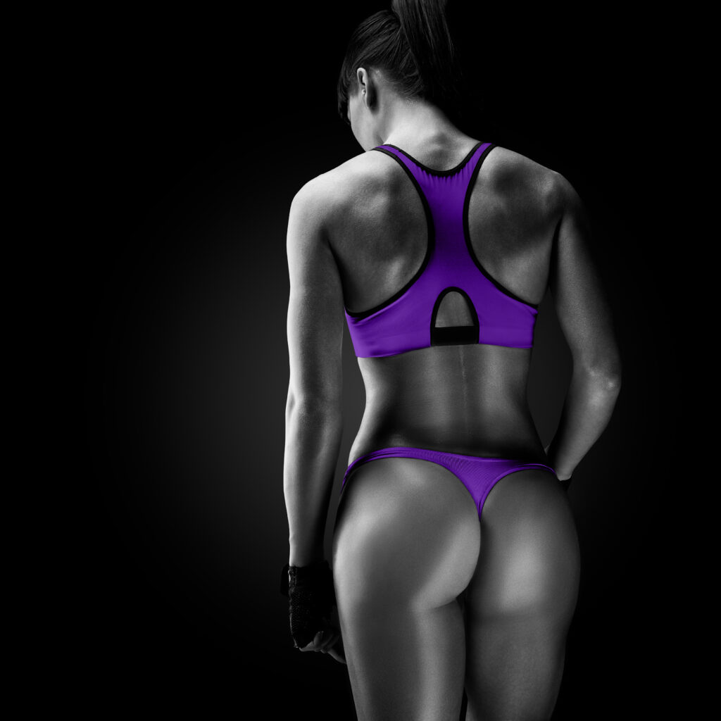 Female athlete showing back muscle definition during Scottsdale neuromuscular activation training for strength and performance improvement