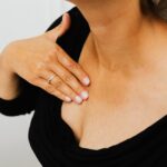 Thoracic outlet syndrome management focus on upper chest and collarbone discomfort, person touching the clavicle area