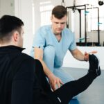 Sports physical therapist performing leg assessment on active adult patient in Scottsdale